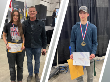 Two student winners pose for photo with their medals