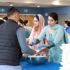 Adults receiving their lunch from the ATS PAC