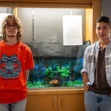 student artists in front of their artwork